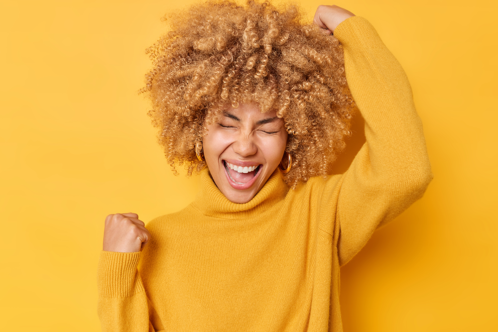 A woman excited for Inkwright, Inc.'s Weekly Writing Workshop.